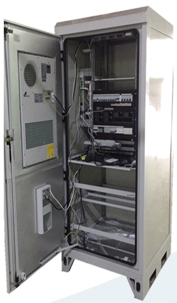Open outdoor cabinet with equipment racks