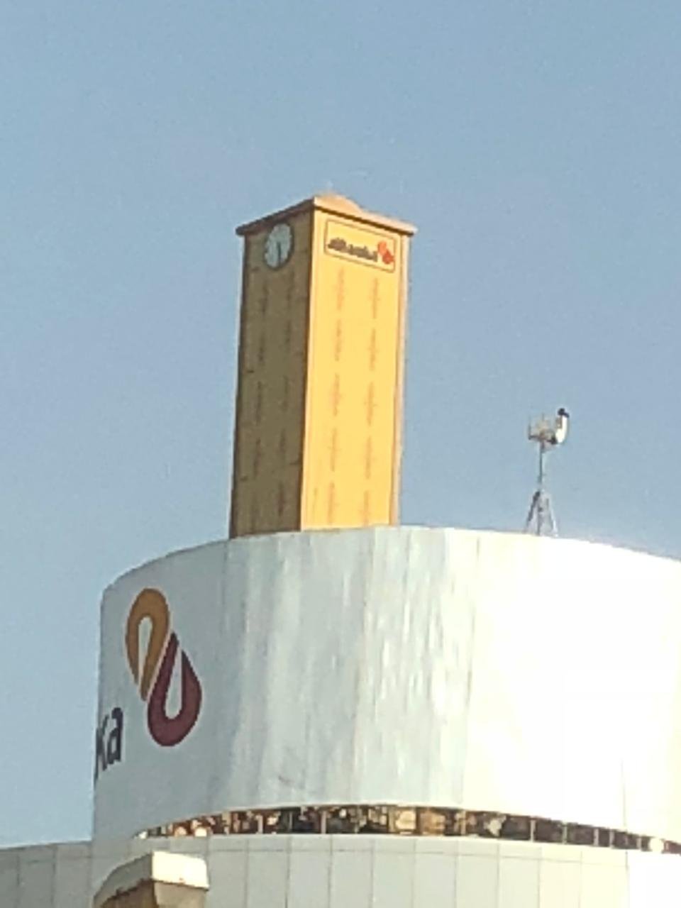 Clock tower camouflage on a building rooftop, Sudan