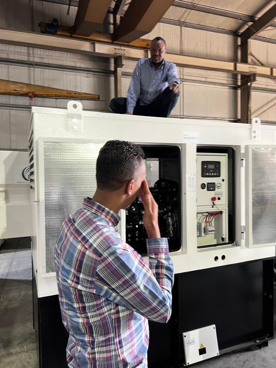 Diesel generator being inspected before shipping