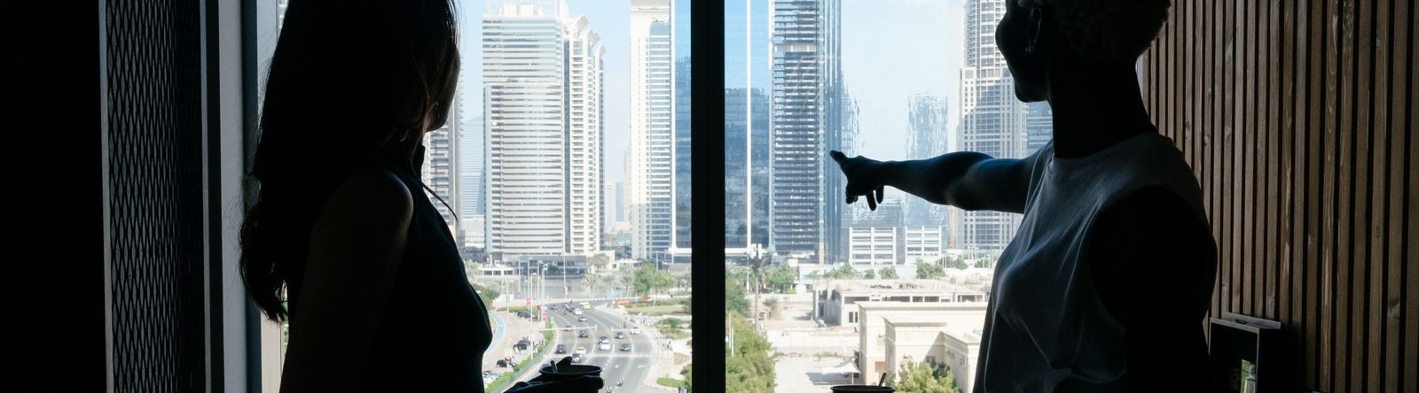 Colleagues in conversation overlooking the Dubai skyline