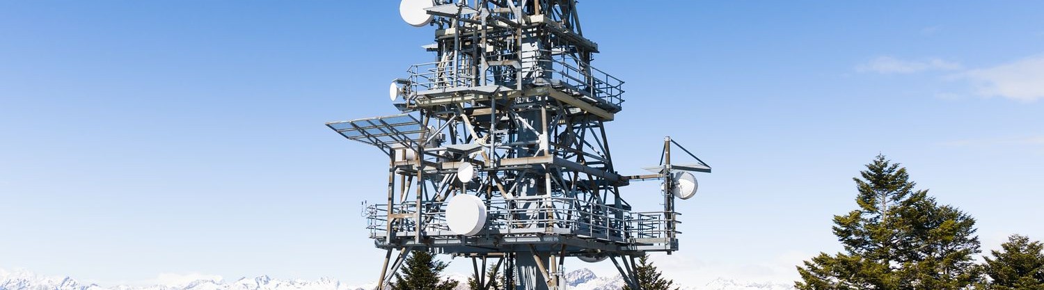 Telecom tower powered by a solar panel array in a mountain setting