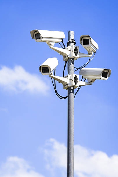 Four outdoor security cameras mounted on a pole